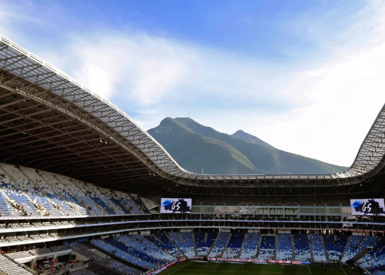 Open-air Football Stadium with Blue and White Seats and a Mountain Backdrop Under a Clear Sky | Tu Colonia Nuevo León
