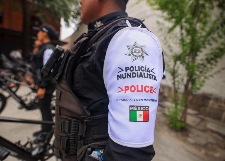 Police Officer in Tactical Gear with a White Shoulder Patch Reading 'policÍa Mundialista' and 'police' Alongside the Mexican Flag. | Tu Colonia Nuevo León